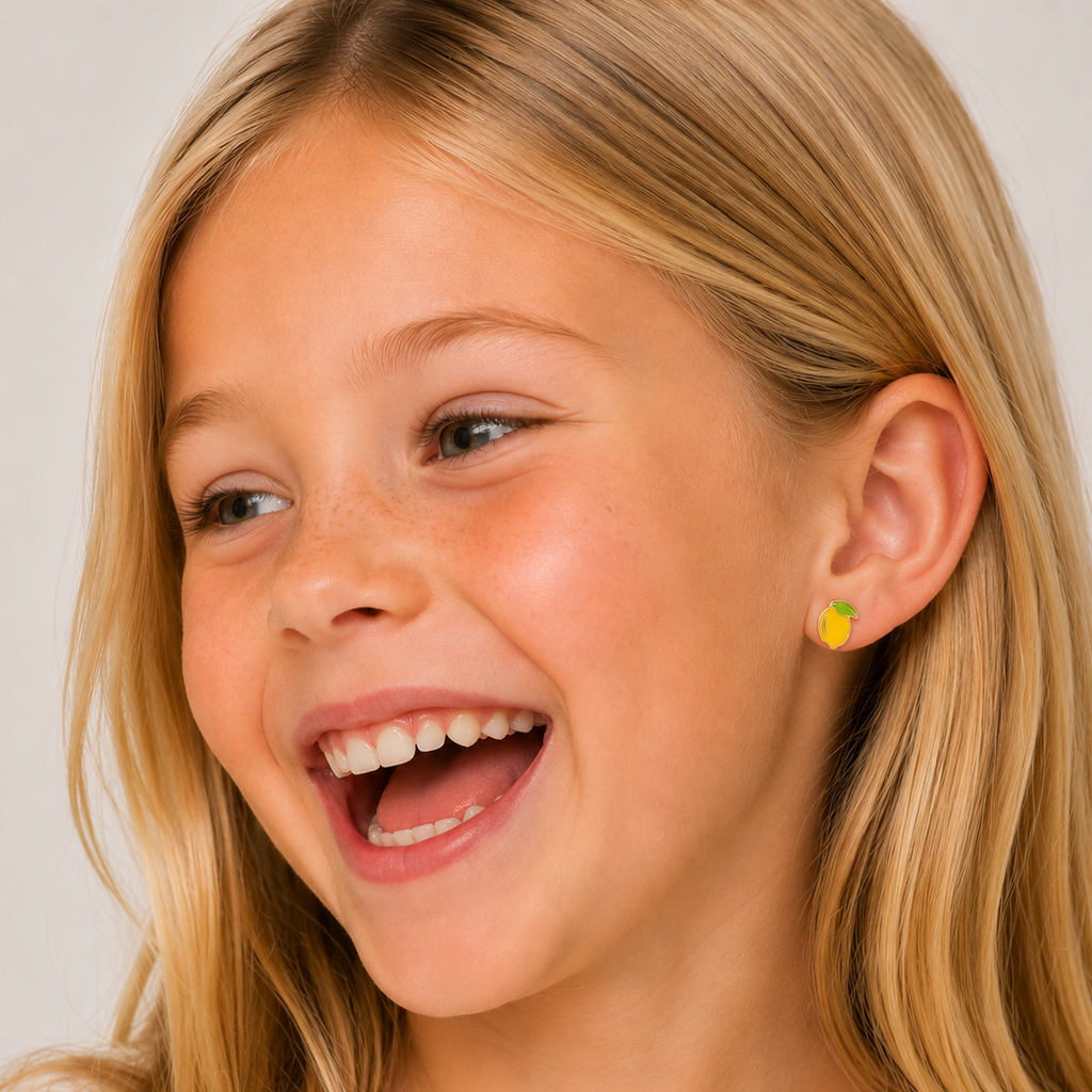 Close-up of a young girl with blonde hair and a white shirt, wearing a yellow earring.