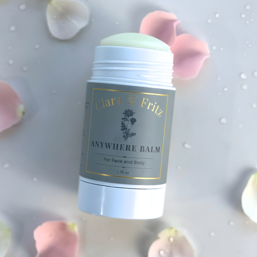Balm container labeled 'Chica & Fritz Anywhere Balm' with floral elements in the background