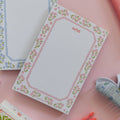 Pink floral 4x6 notepad with hand-illustrated floral border and notes header for everyday lists and reminders.