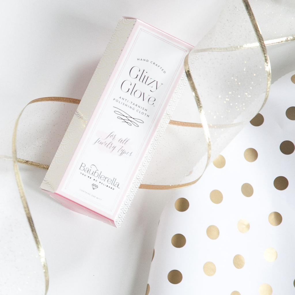 Bailarina Glizzy Glove packaging with a gold polka dot towel on a white background