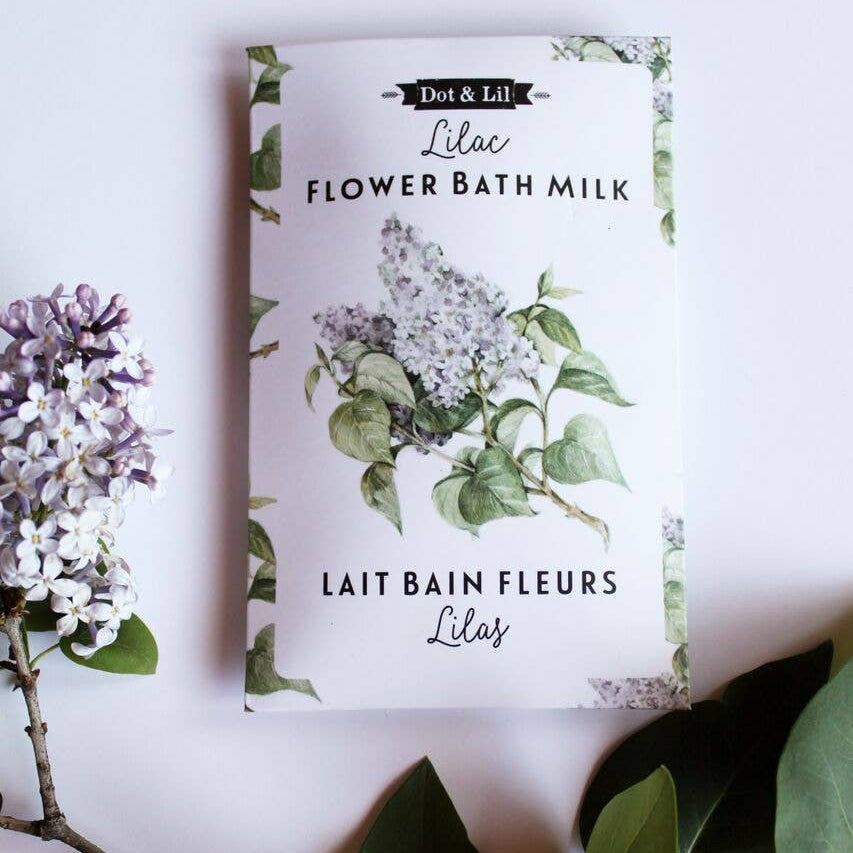 Bath milk packaging with floral design and text on a light background