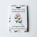 Packaging of Dot & Lil Peony & Olive Leaf Flower Bath Milk on a light gray background