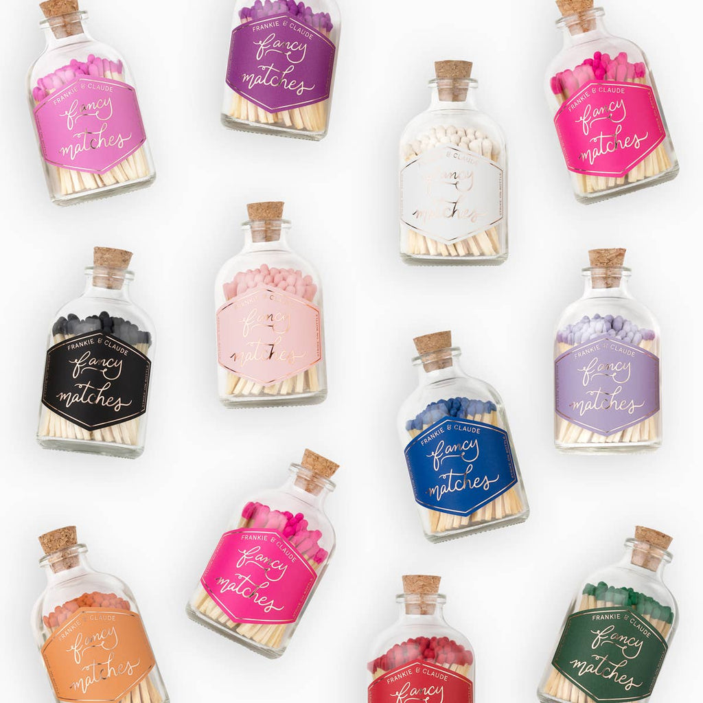Collection of decorative match bottles with colorful labels on a white background