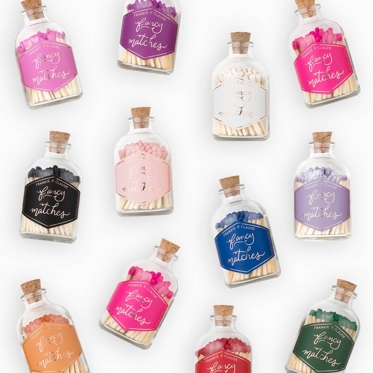 Collection of decorative match bottles with colorful labels on a white background
