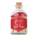 A clear glass bottle with a cork stopper filled with red-tipped matches and a red label reading 'FRANKIE & CLAUDE fancy matches' on a white background.