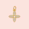 Gold and diamond pendant on a pink background