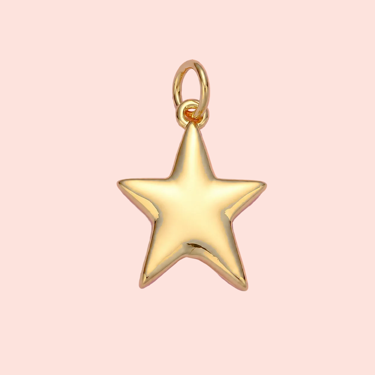 Gold star pendant on a pink background