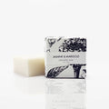 Bar of soap with a decorative packaging label on a white background