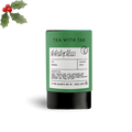 Tea packaging with a label and holly leaves on a white background