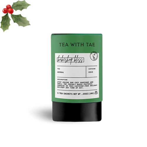 Tea packaging with a label and holly leaves on a white background
