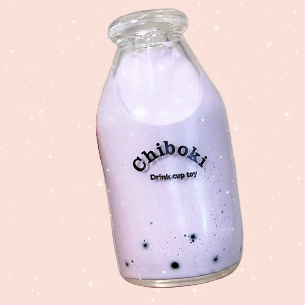 Hand holding a purple bottle with 'Chiboki' branding against a plain background