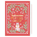 Card with 'Nutcracker Playing Cards' text and decorative elements on a red background