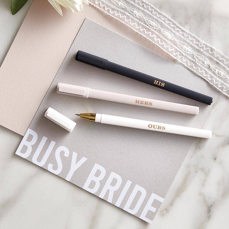 Three pens labeled 'HIS', 'HERS', and 'OURS' on a card with 'BUSY BRIDE' text.