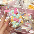 Colorful marshmallow-like toy with a heart-shaped keychain in a clear package.