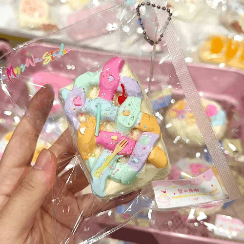 Colorful marshmallow-like toy with a heart-shaped keychain in a clear package.