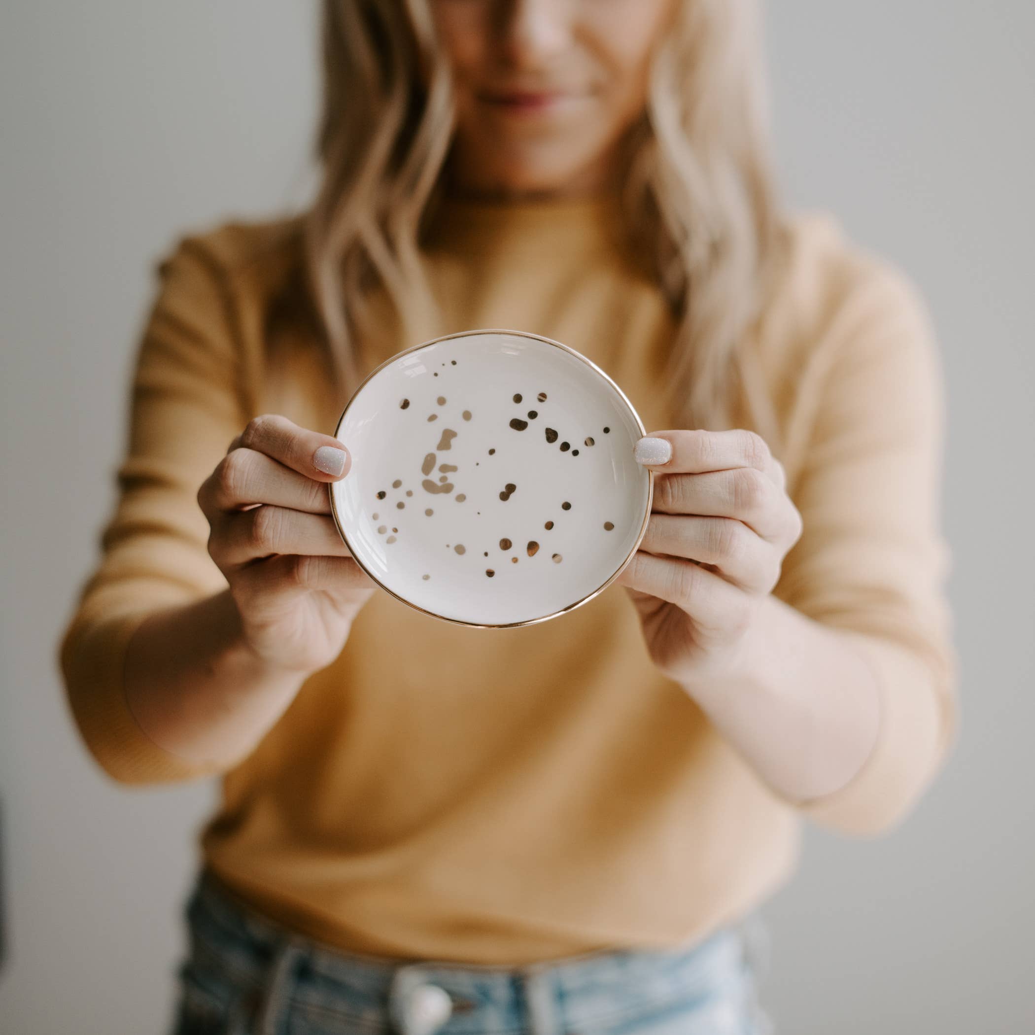 Person holding a ceramic mug with a textured surface