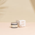 Nipple balm jar and packaging on a beige background
