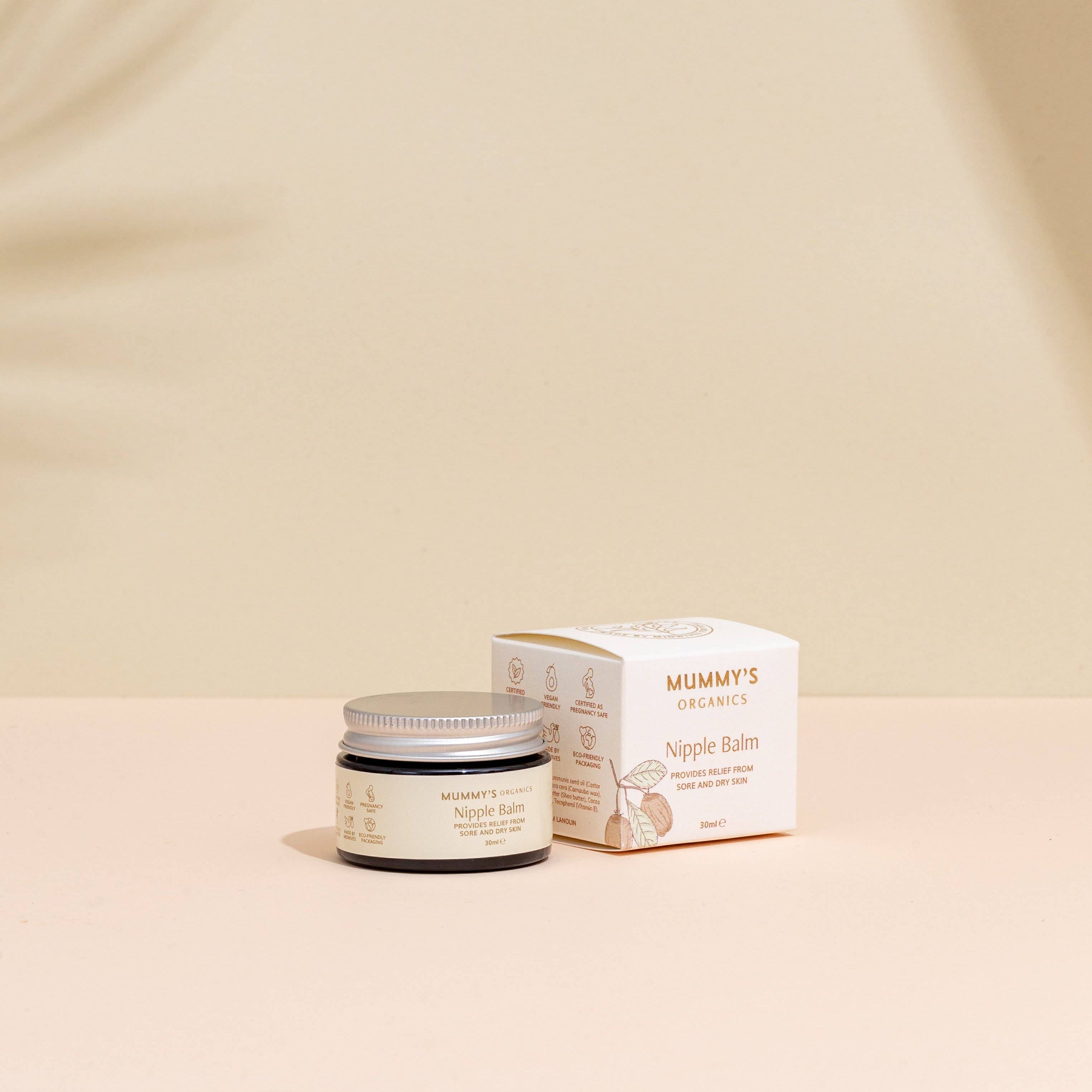 Nipple balm jar and packaging on a beige background