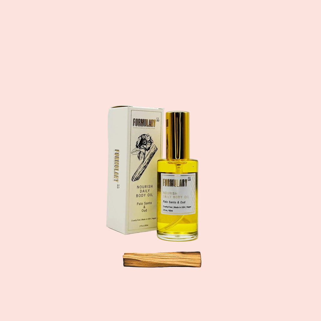 Bottle of perfume with packaging and wooden stick on a white background