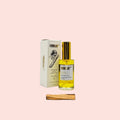 Bottle of perfume with packaging and wooden stick on a white background