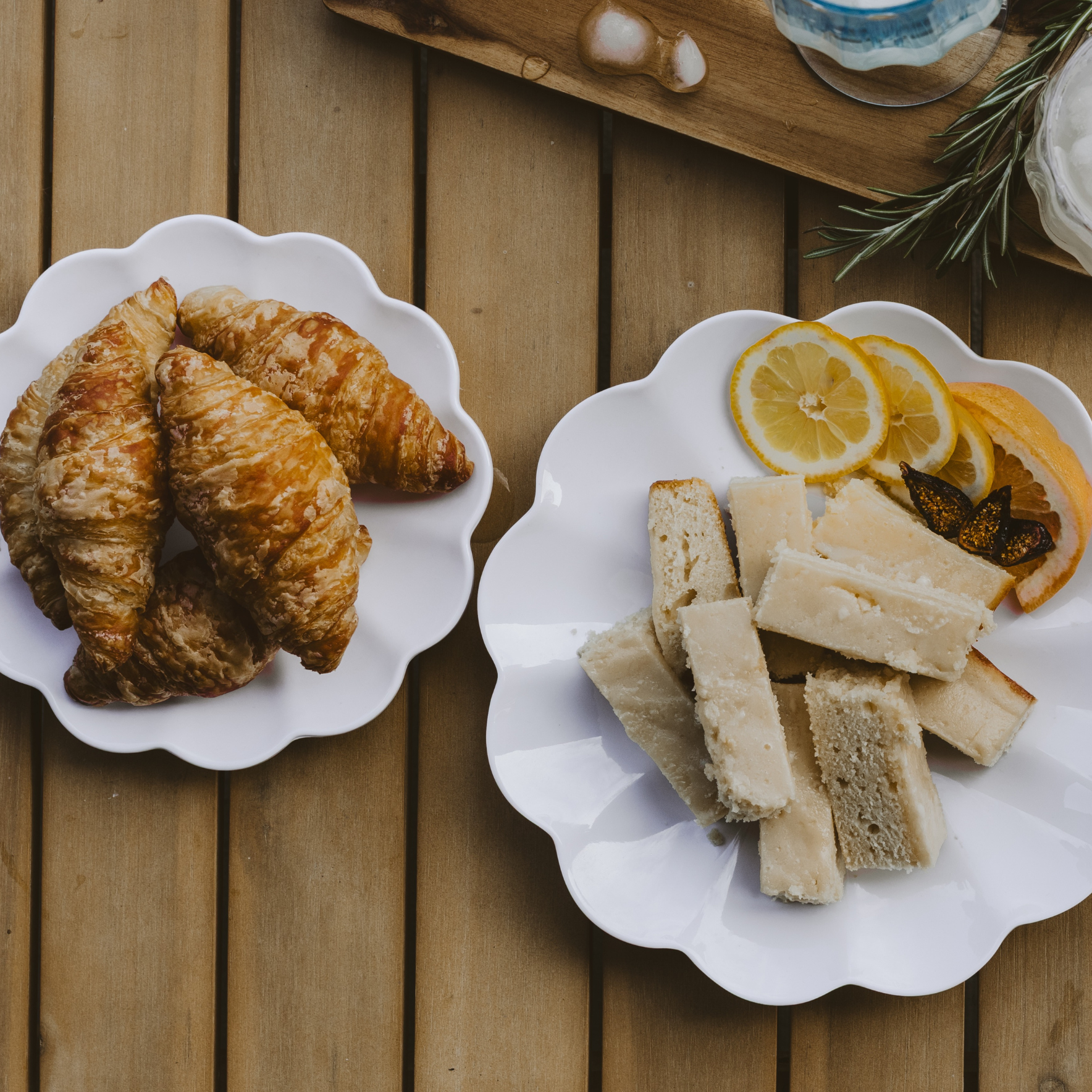 Two plates of pastries on a wooden surface