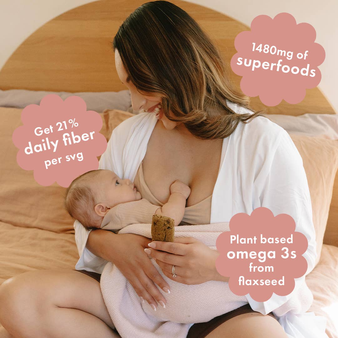 Mother breastfeeding her baby while enjoying a Milk to the Max Lactation Bar by Boobie Superfoods, featuring 1,480 mg of milk-boosting superfoods, plant-based omega-3s from flaxseed, and fiber to support breastfeeding moms.