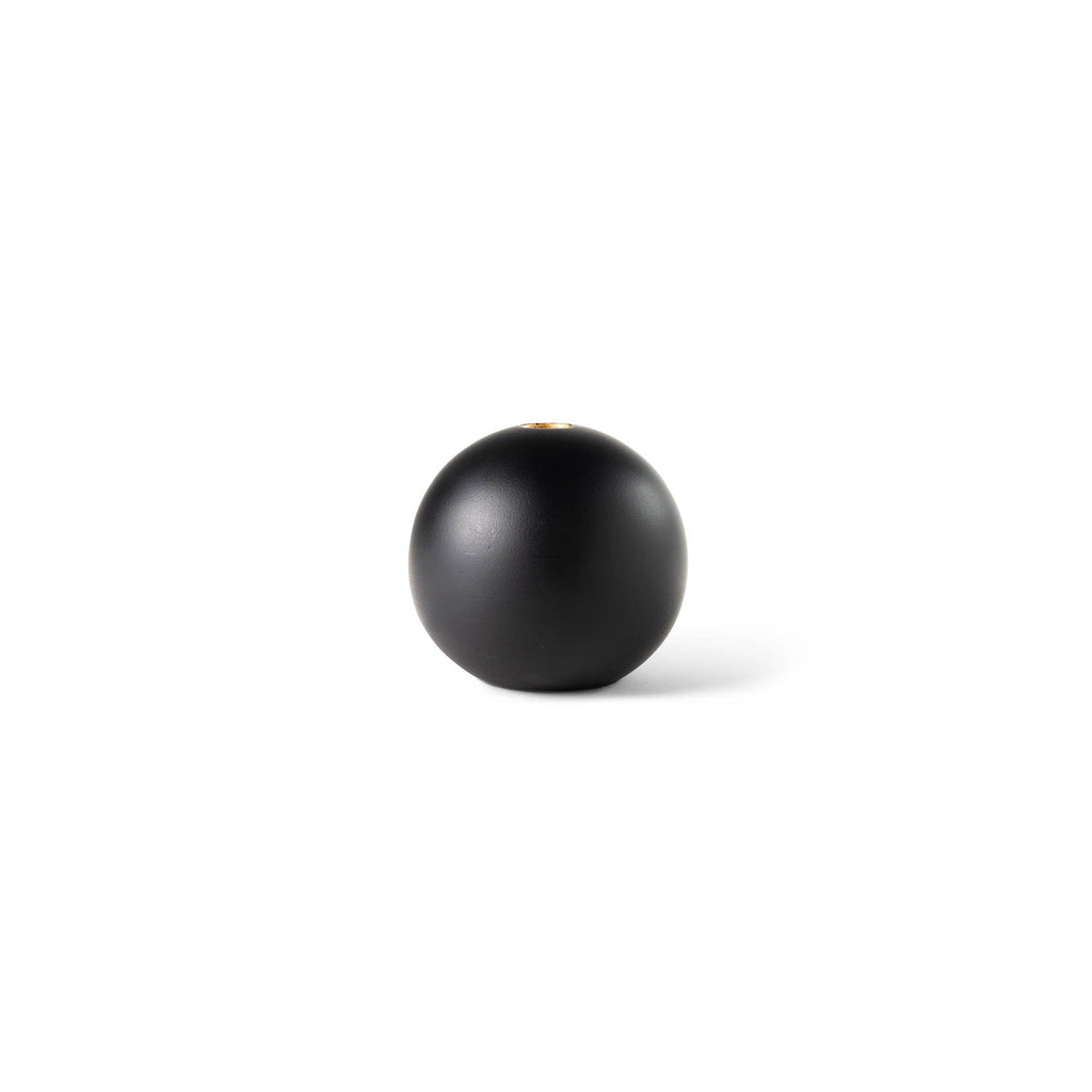 A matte black spherical object, possibly a decorative vase or container, centered on a plain white background with a soft shadow.