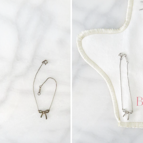 Two necklaces with bow designs on a white background