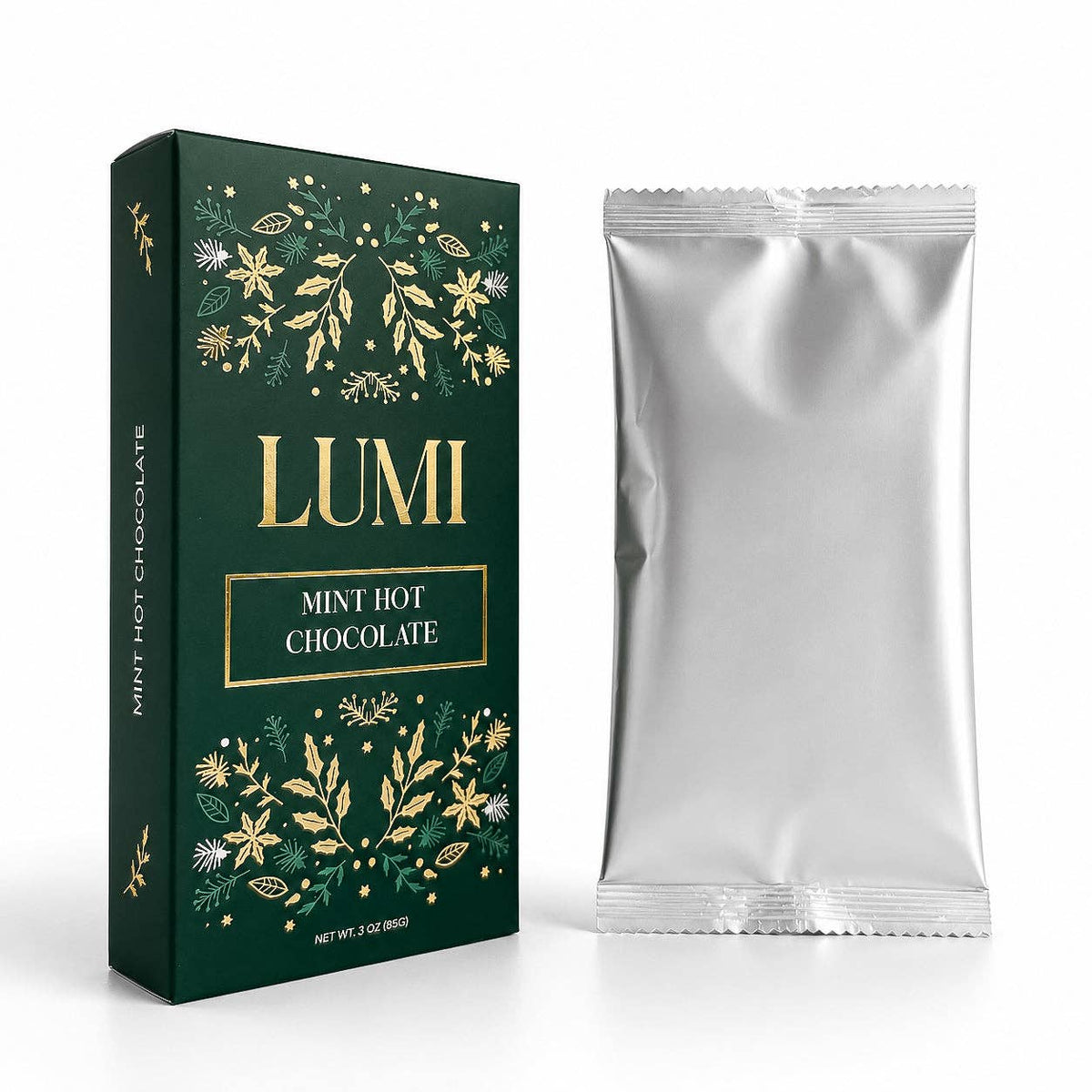 A dark green box of LUMI Mint Hot Chocolate with gold botanical illustrations and a silver foil packet standing beside it on a white background.