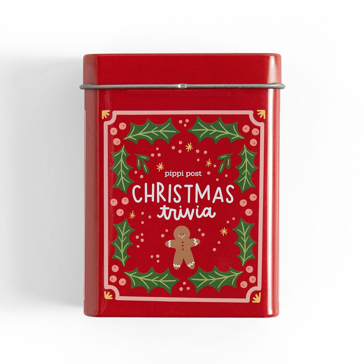 Red tin box with Christmas-themed design and text on a white background