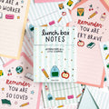 Collection of lunch box notes with motivational messages and illustrations on a colorful background.