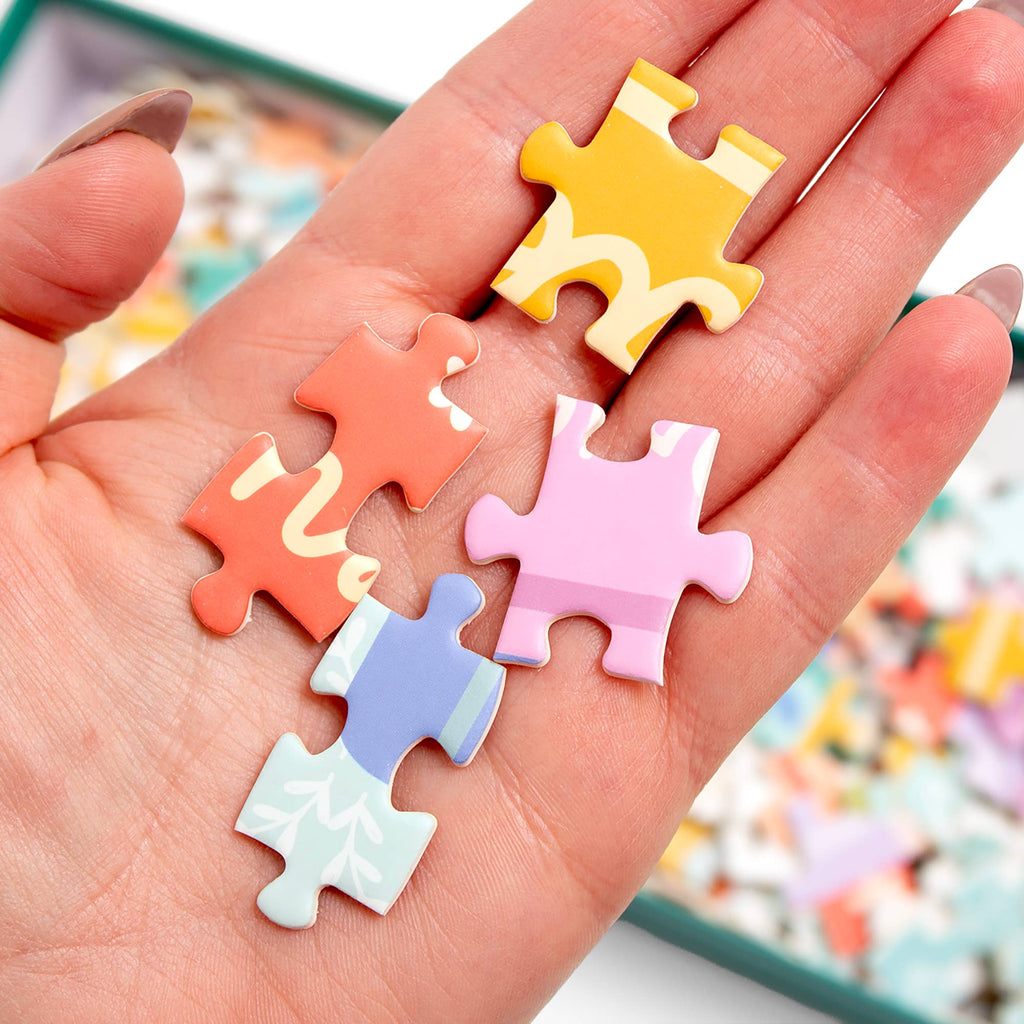 Close-up of interlocking puzzle pieces featuring colorful Jane Austen bookshelf illustrations.