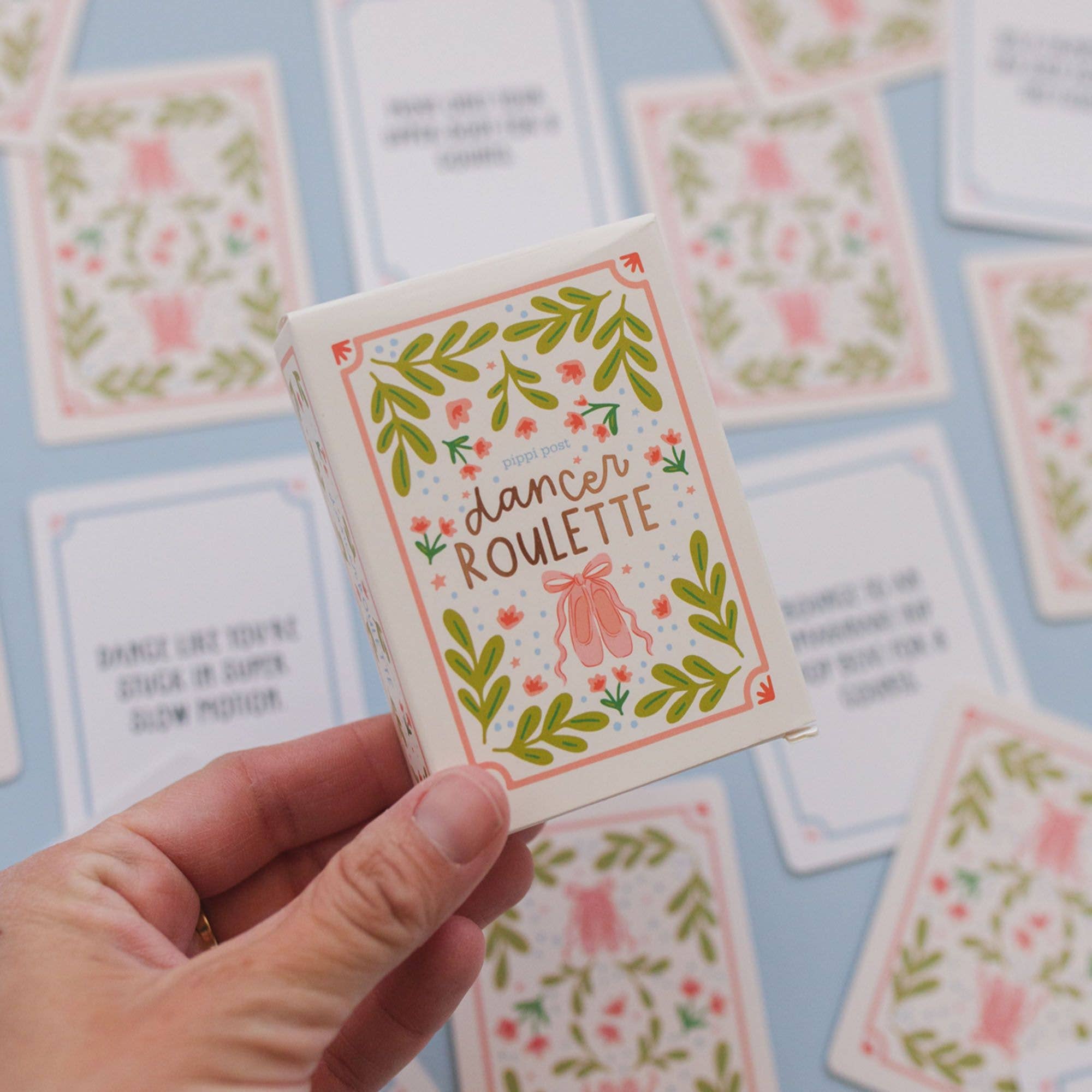 Hand holding a Dancer Roulette activity card with a fun dance prompt.