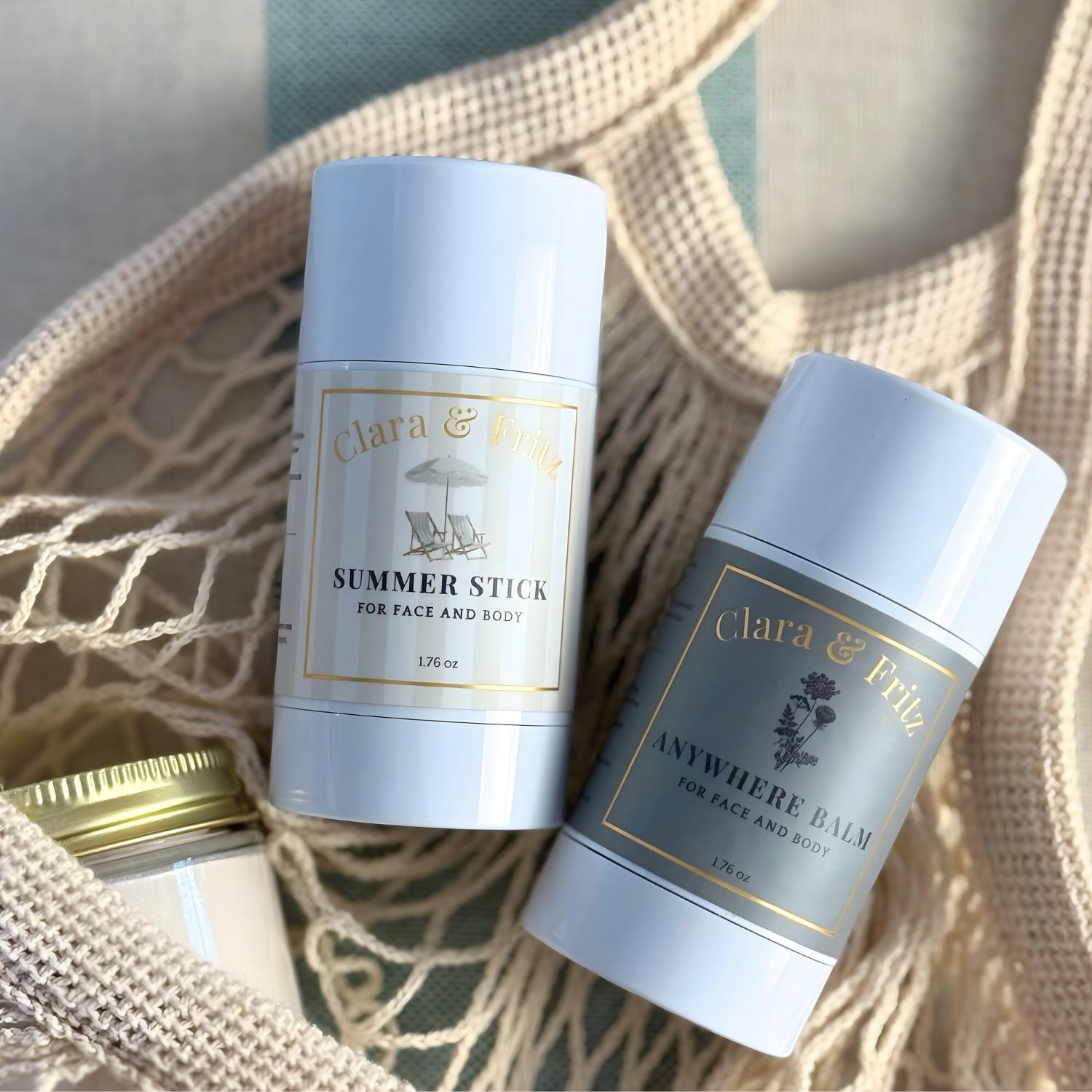 Two skincare products from Clara & Fritz on a textured surface