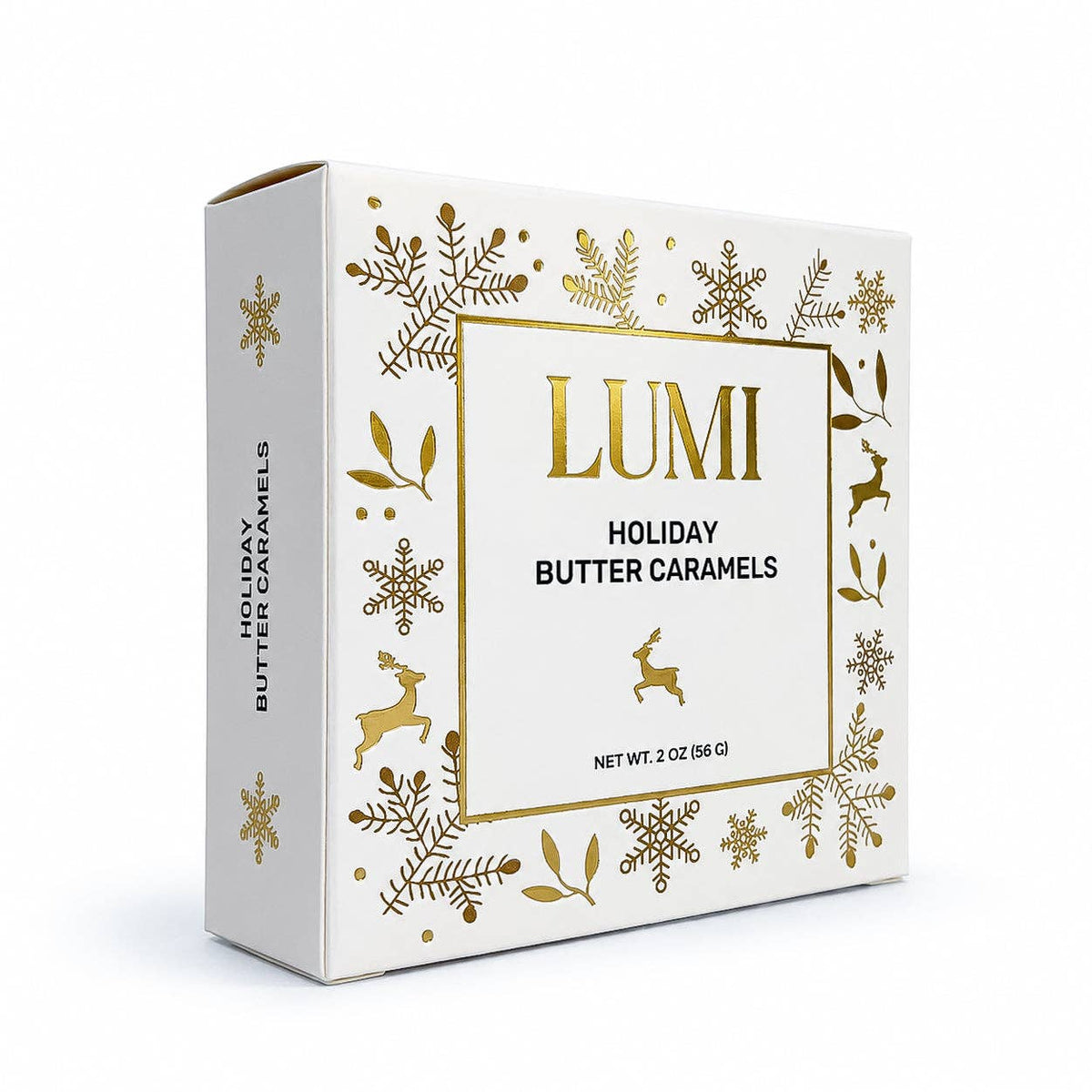 A box of Lumi Holiday Butter Caramels, featuring a white packaging design decorated with gold foil snowflakes, leaves, and deer, on a clean white background.