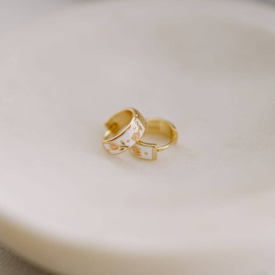Two gold rings on a light beige surface