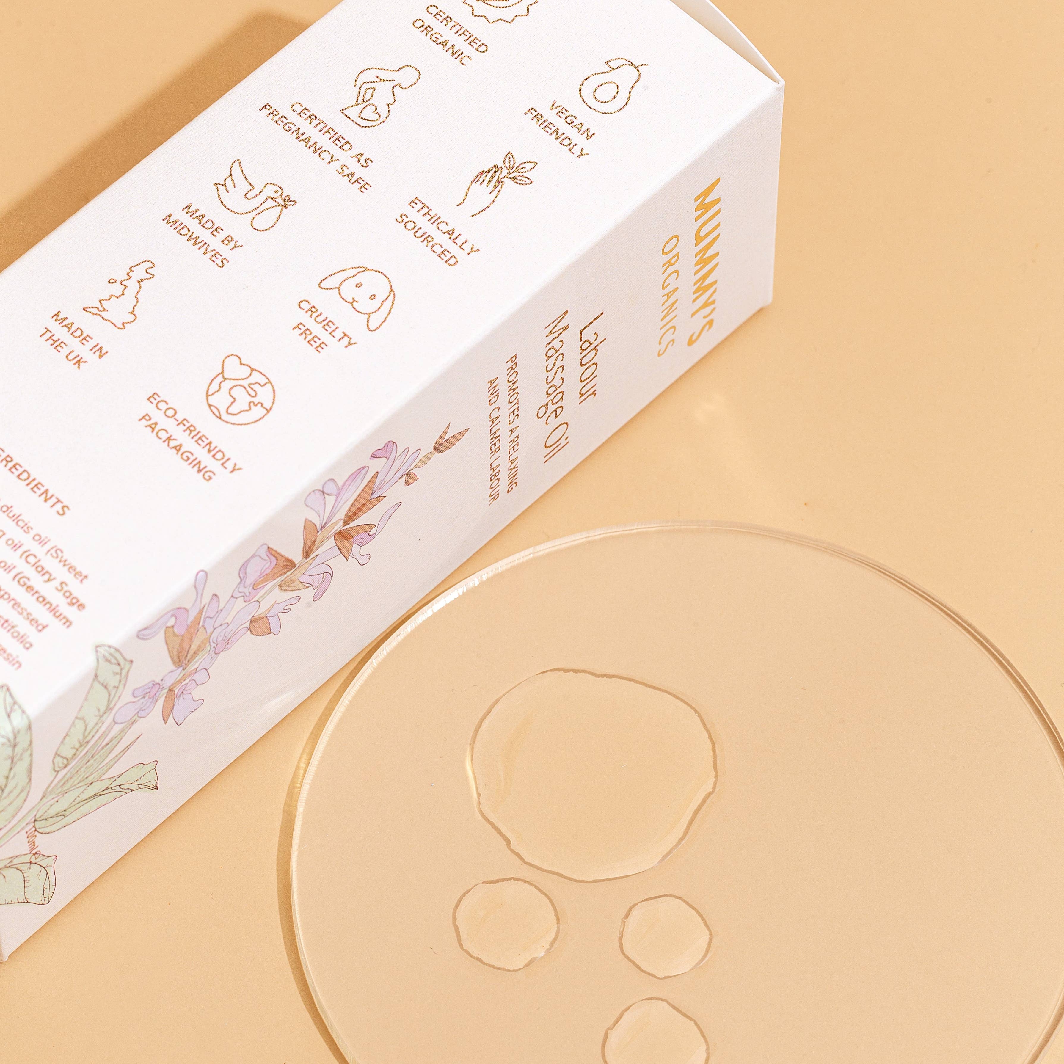 Natural Labour Massage Oil by Mummy's Organics with calming essential oil blend displayed beside massage oil for pregnancy, labour support and relaxation.