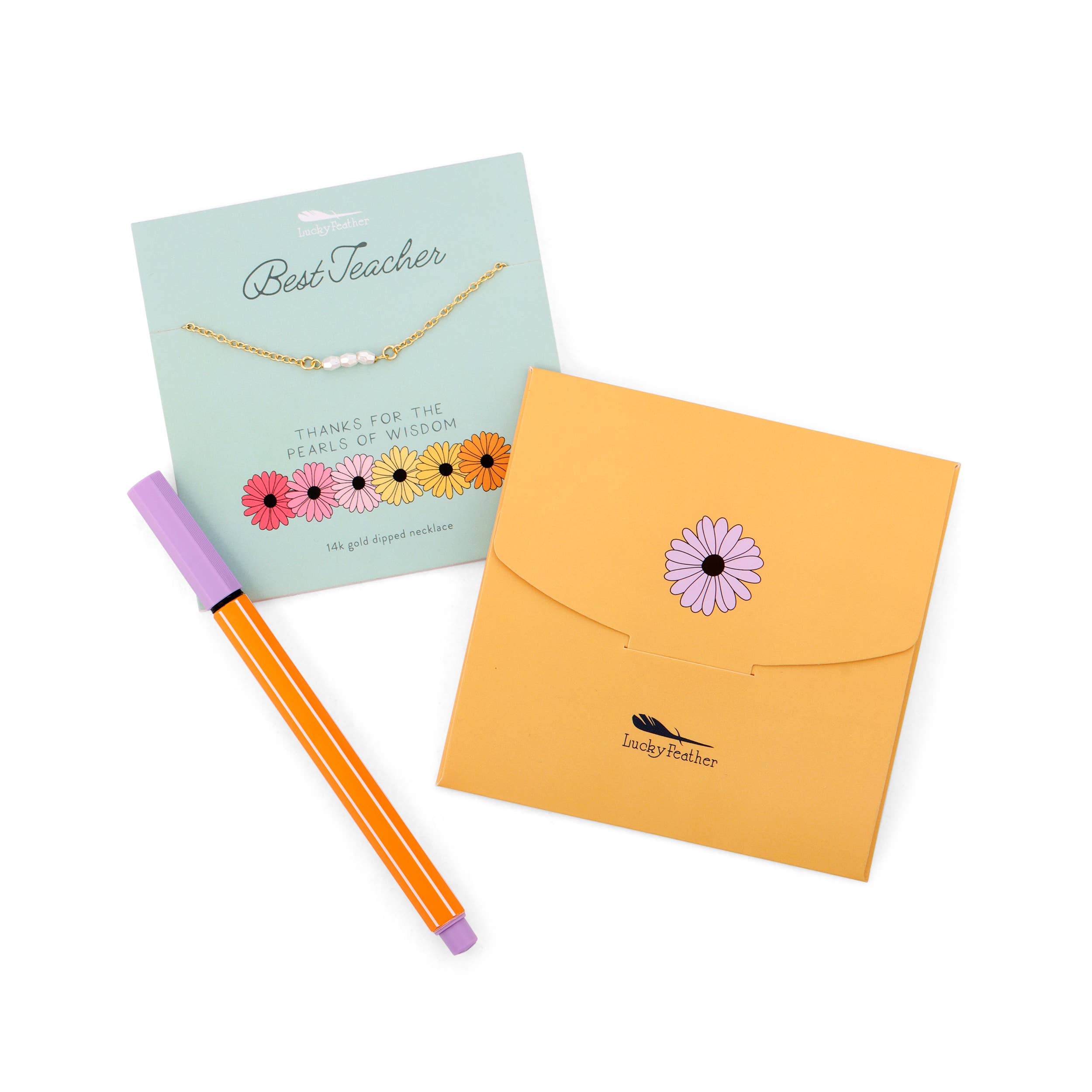 Teacher gift set with necklace, pen, and envelope on a white background