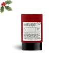 Tea package with label and holly leaves on a white background