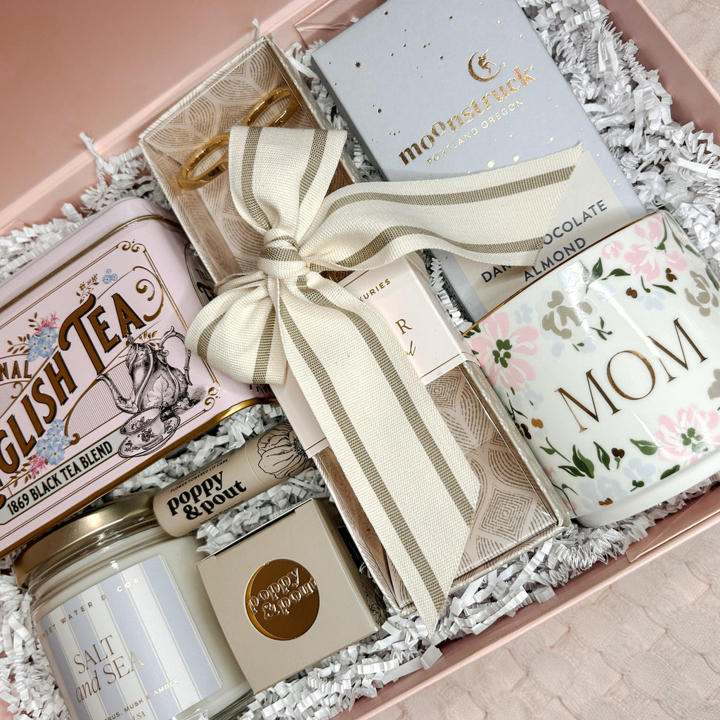 Gift set with tea, candle, and card in a decorative box