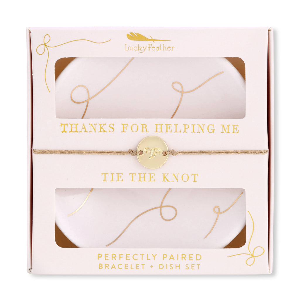 Packaged bracelet and dish set with 'Lucky Feather' branding and text.