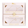 Packaged bracelet and dish set with 'Lucky Feather' branding and text.