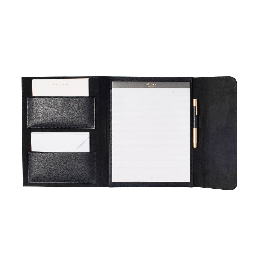Executive faux leather padfolio opened to reveal a lined legal writing pad, coordinating gold pen, business card pockets, document storage, and correspondence cards with envelopes. A professional portfolio designed for meetings, work, and everyday organization.