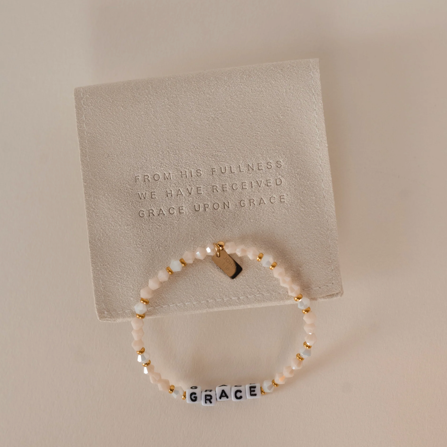 Bracelet with 'GRACE' on a card with text on a beige background