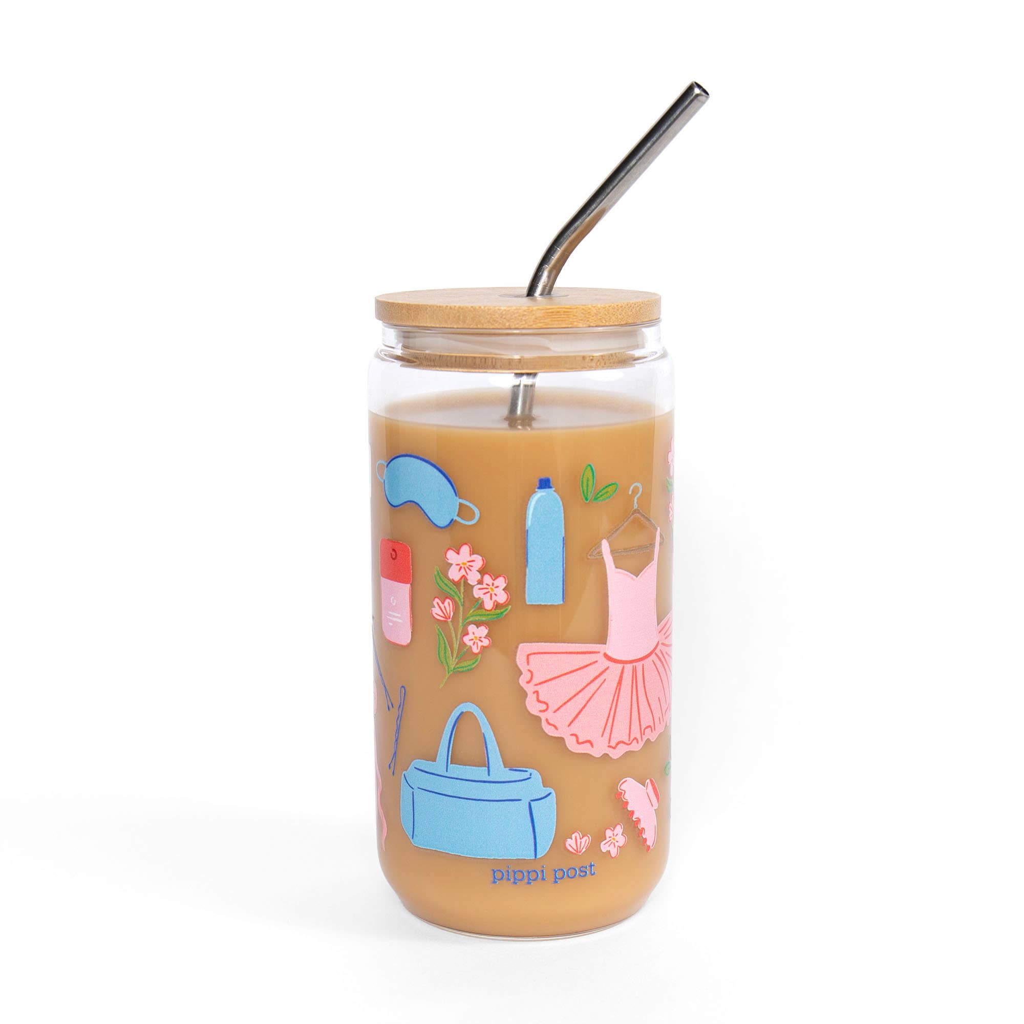 A clear glass jar tumbler with a light wood lid and a black metal straw, filled with an orange-brown beverage. The glass features colorful illustrations of fashion items like a pink tutu, blue handbag, and pink flowers.