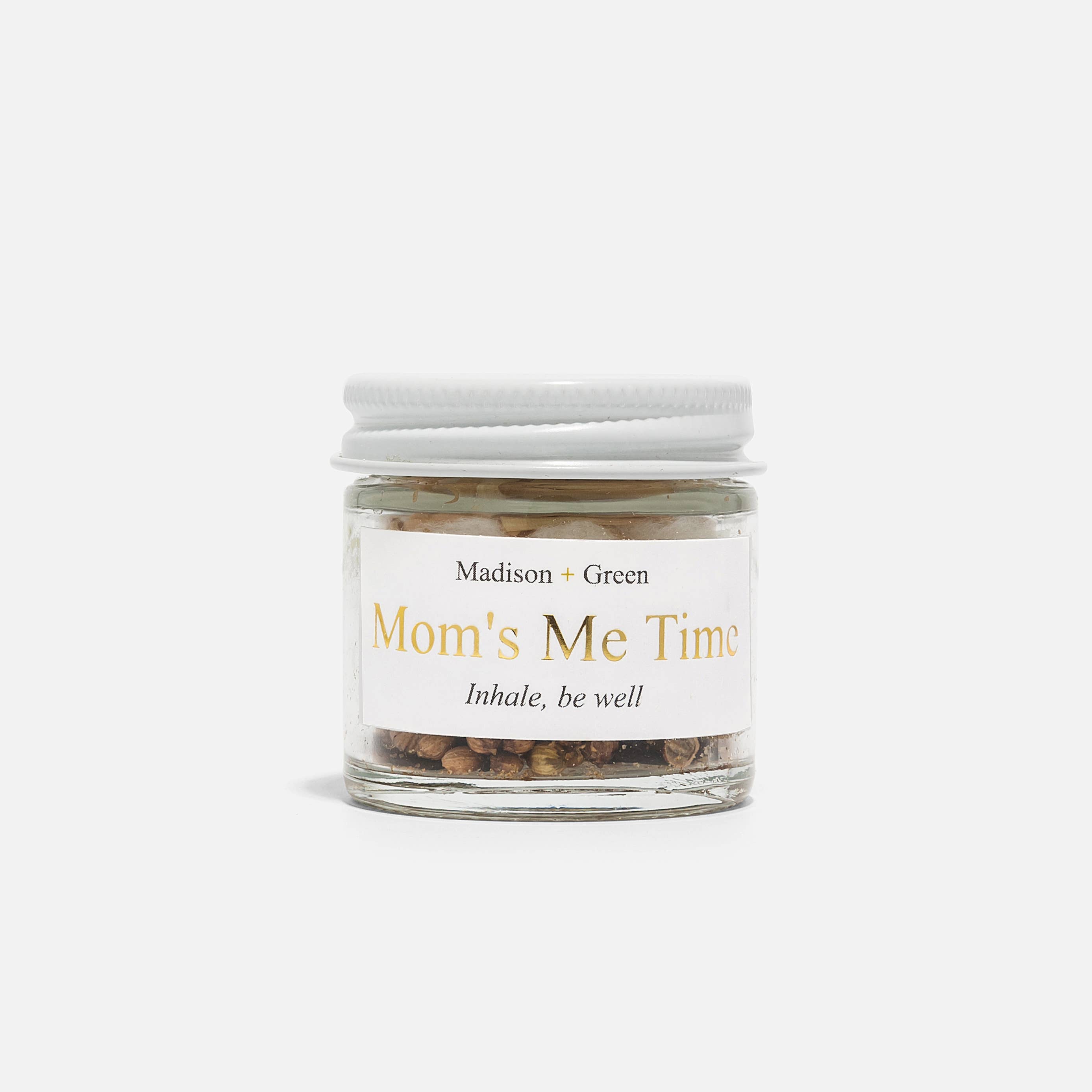 Glass jar labeled 'Mom's Me Time' with a white lid on a white background