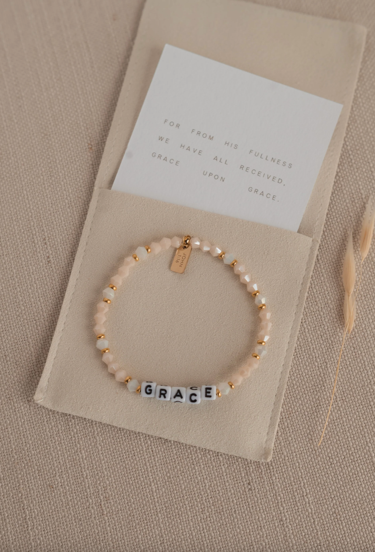 Bracelet with 'GRACE' beads on a beige card with text