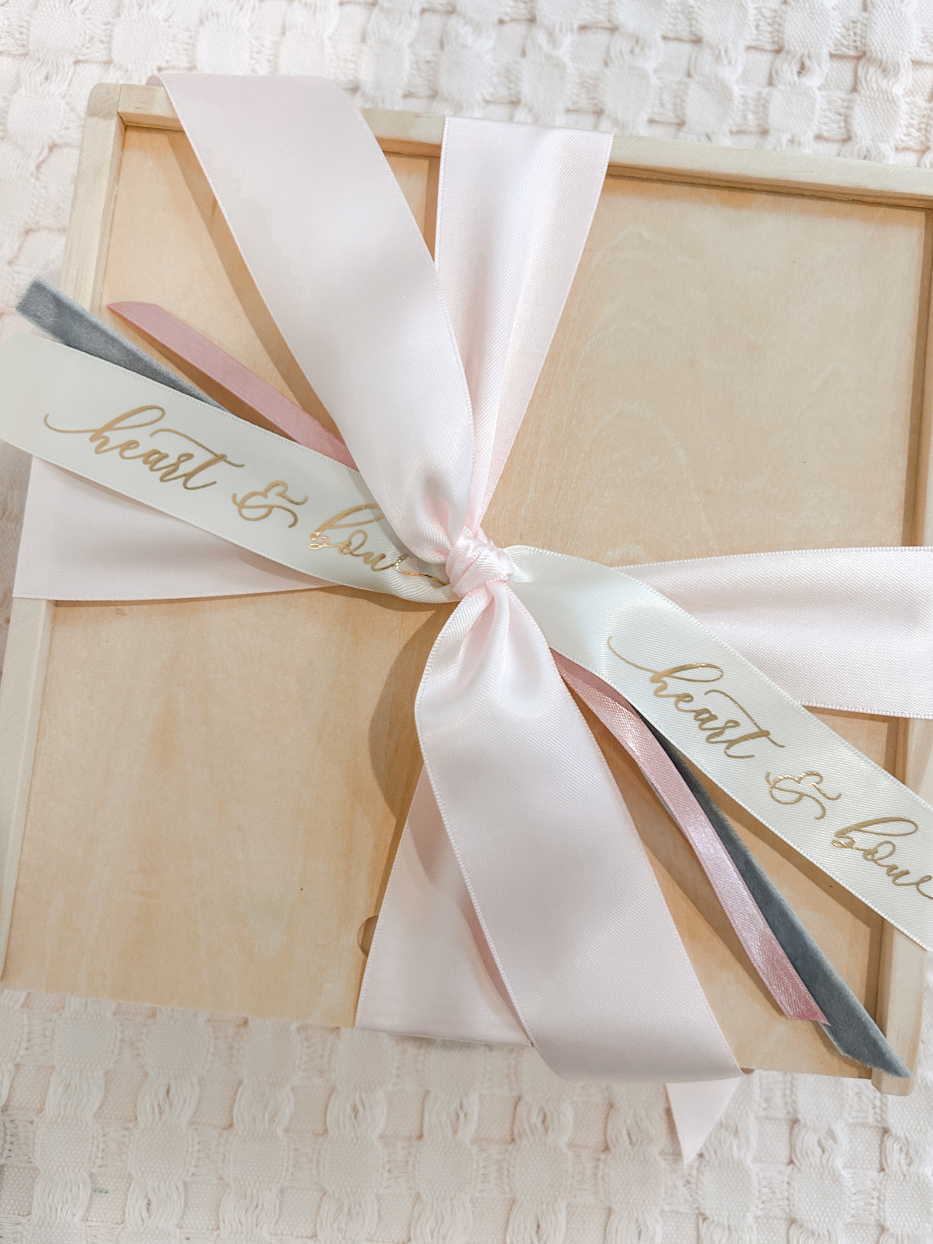 Gift box with a ribbon and 'heart & love' tag on a textured surface