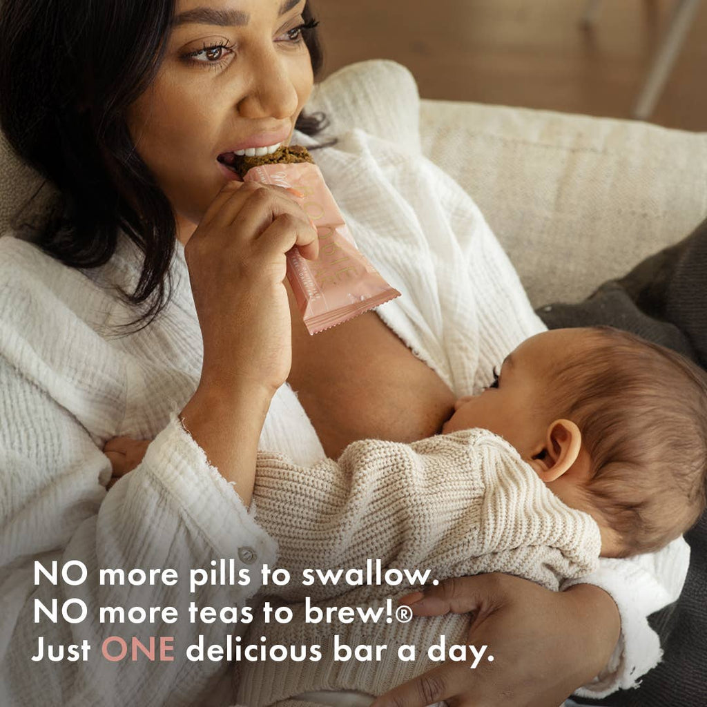 Mother breastfeeding her baby while enjoying a Boobie Superfoods Milk to the Max Oatmeal Chocolate Chip Lactation Bar, a convenient breastfeeding snack that supports healthy milk supply with milk-boosting superfoods.