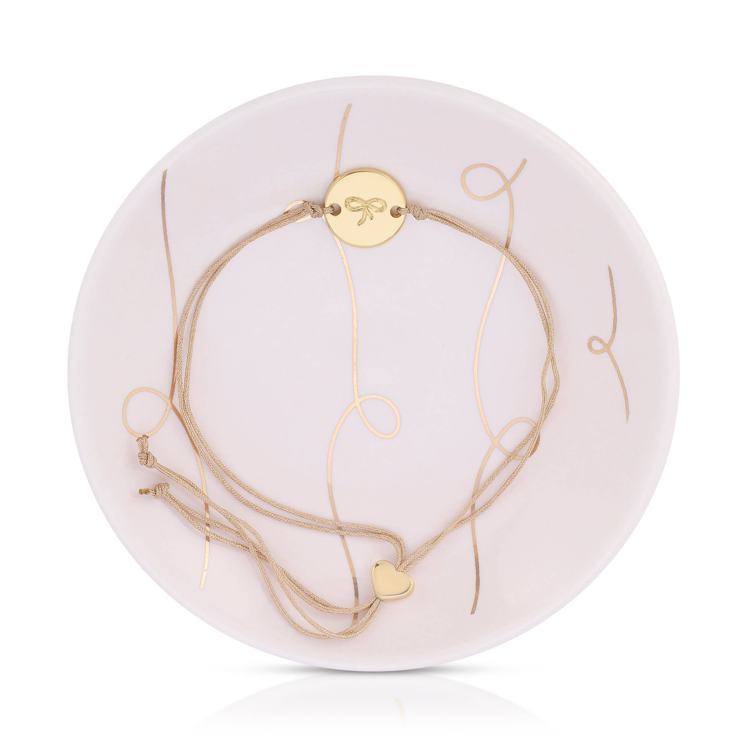 Set of gold necklaces on a white circular stand with a brand logo.